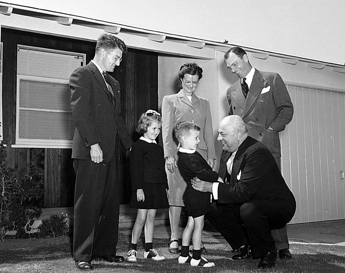 Henry J. Kaiser greets the George family at the Kaiser Community Homes