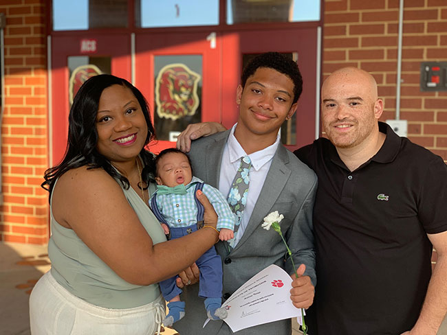 Anonya family smiling at sons graduation