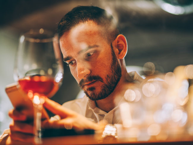 Man drinking while on phone