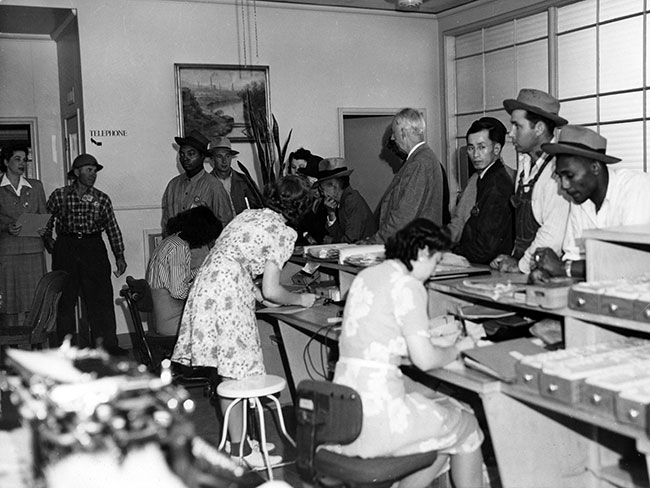 A diverse group of Kaiser shipyard workers at Richmond Field Hospital lobby, 1943.