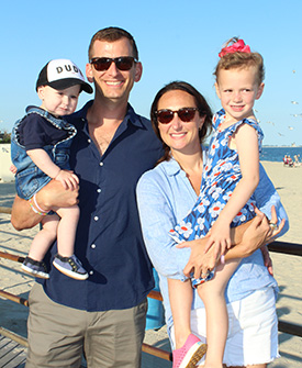 parents with 2 children on a beach