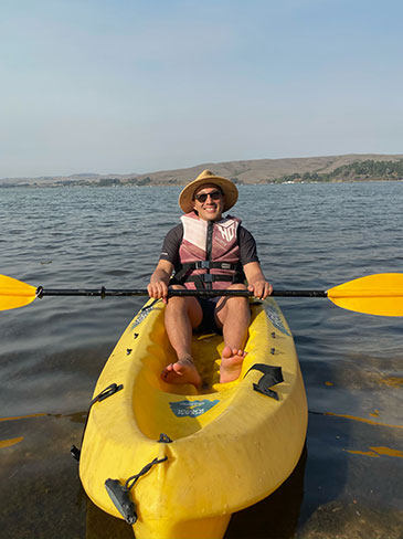 Adrian Cheong smiling in a canoe