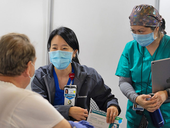 Health care workers at a mass vaccination site