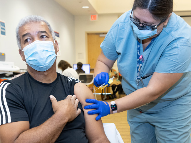 man receiving vaccination for COVID-19