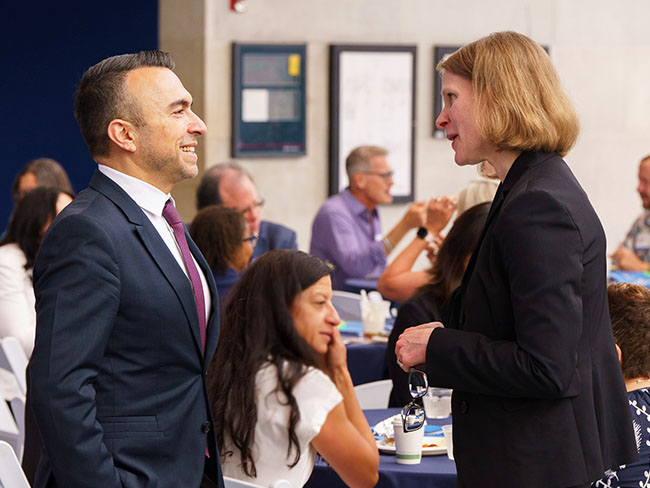 two people talking at conference.