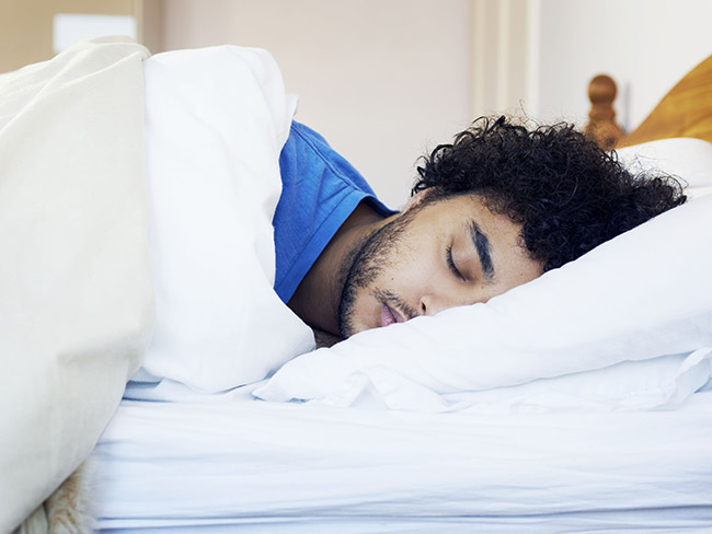 Man sleeping in bed.