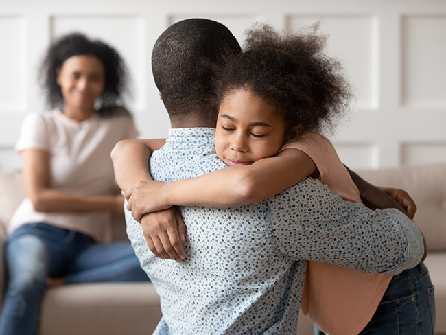 young girl embracing her father