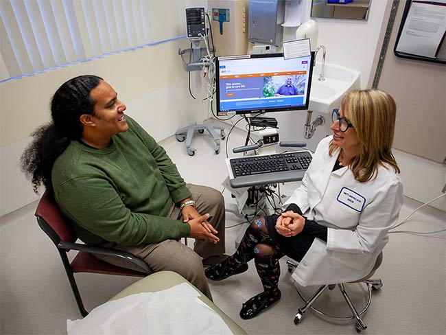 Doctor talking with patient in exam room