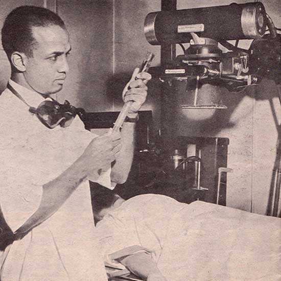 black and white image of a doctor preparing a patient for a radiological scan