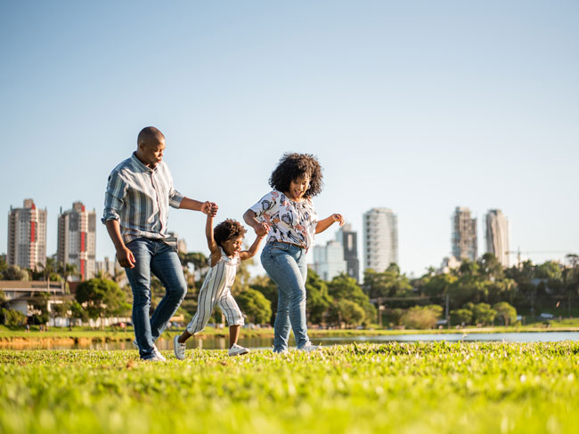 family strolling through a city park