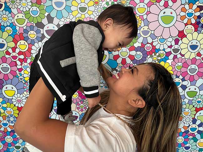 Mom holds her baby up in the air