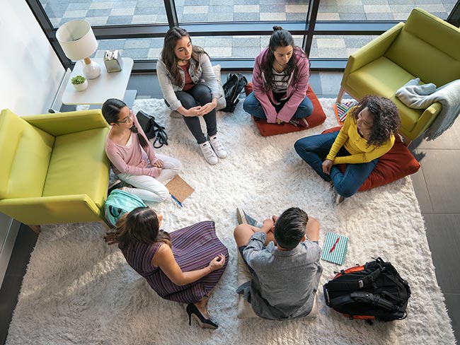 A group therapy session with people sitting in a circle. 