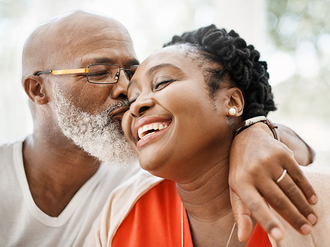 Husband kisses his smiling wife