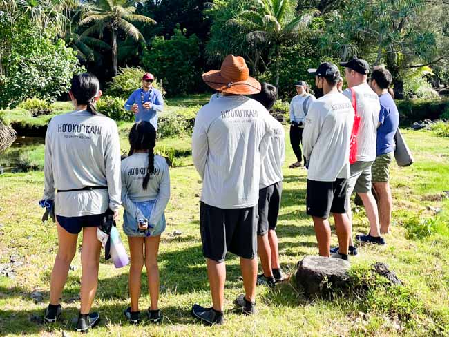 Volunteers listening to site lead.