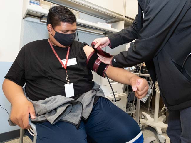 Special Olympics athlete gets a blood pressure reading.