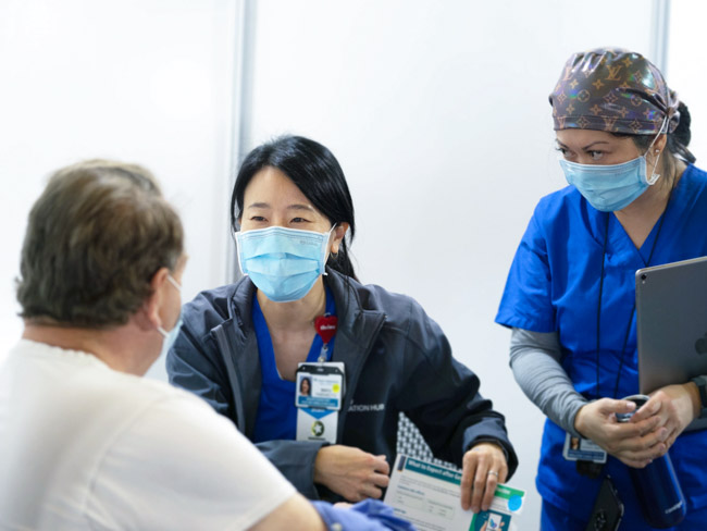 Nurses providing care to a patient.