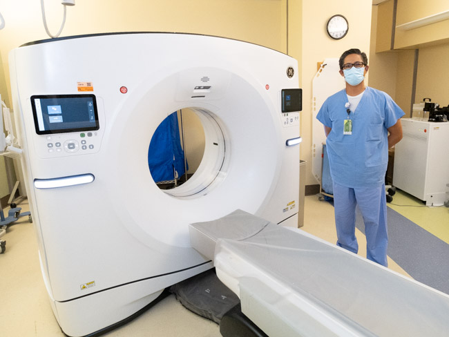 Danny Galura, sr. CT technologist, and the new CT scanner.