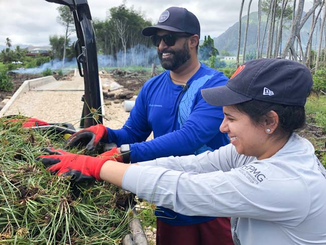 Volunteers loading weeds for disposal.