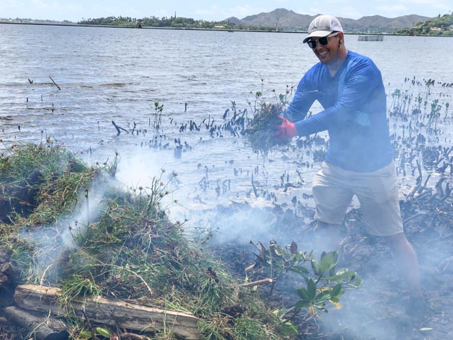 Volunteer disposing of weeds.