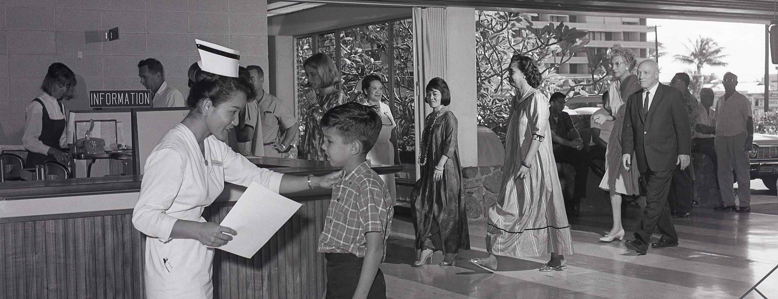 historical image of nurse helping a boy in a medical center lobby