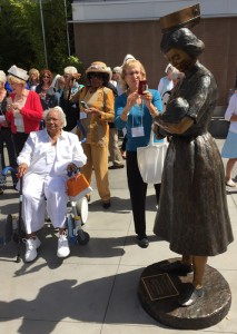 Nurses Dorothy Thomas Hackett and Bonnie Davis Grunseth admiring a sculpture. of a nurse