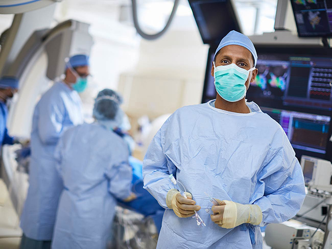 Physician in scrubs and a mask