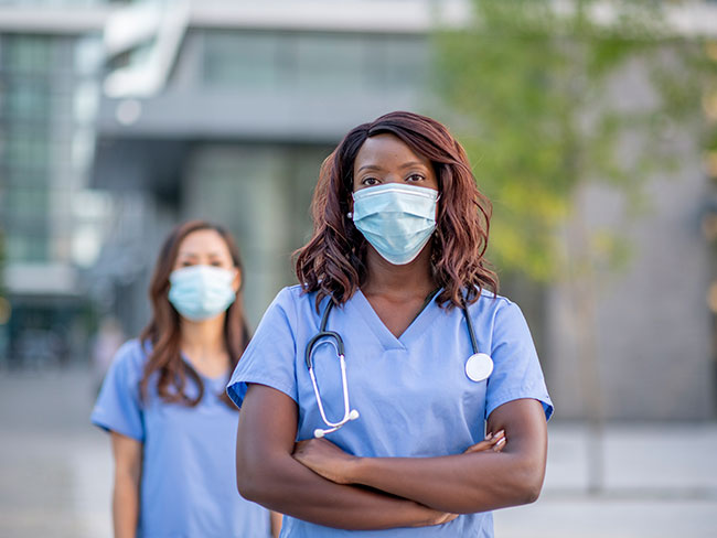 2 medical professionals wearing masks