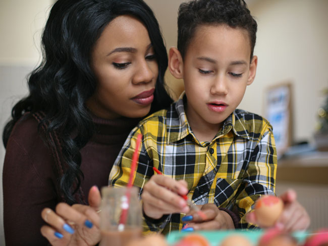 mother and son painting Easter eggs