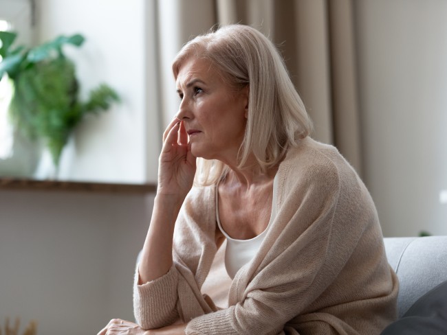 Older woman indoors looking concerned