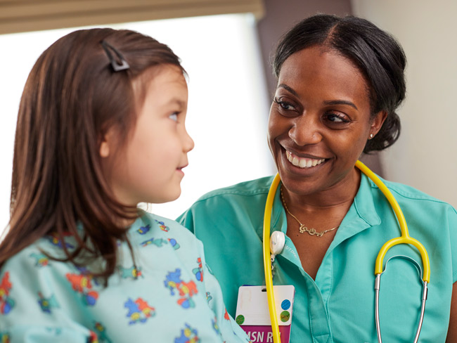 Nurse performing an exam on a young patient