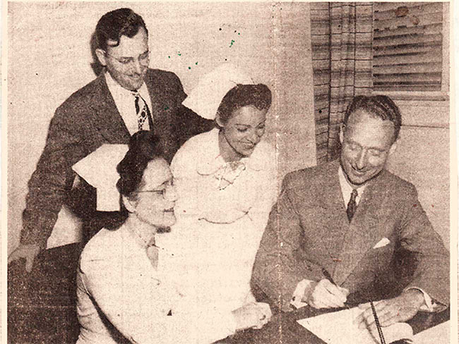 Leaders from the CIO Nurses Guild sitting down with Permanente Foundation hospital administrator signing contract