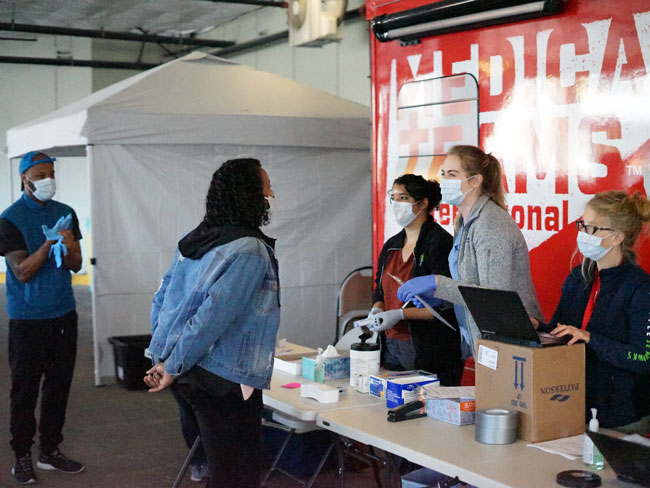 Community members visit mobile health clinic