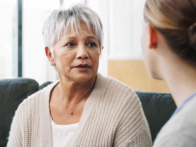 Two women talking about cancer treatment