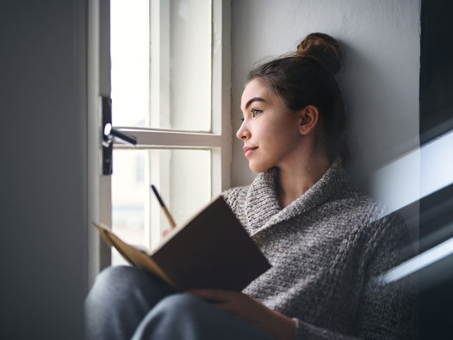 Woman writing in journal