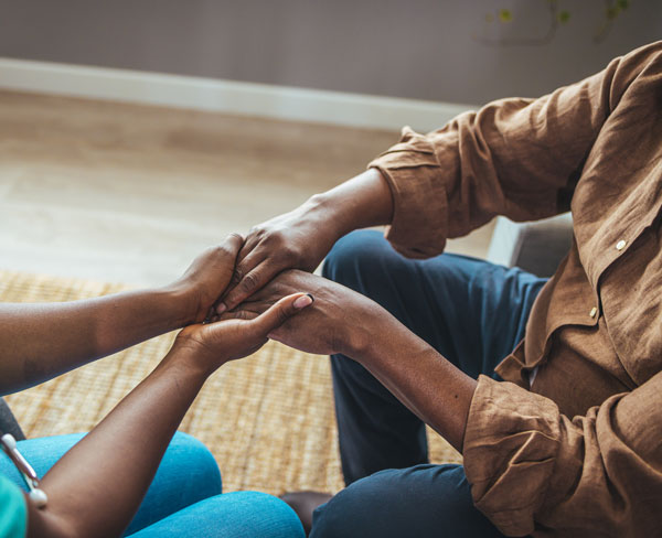 Photo of two people holding hands