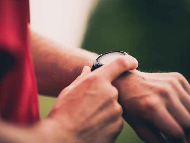 Man wearing a wrist health and fitness tracker