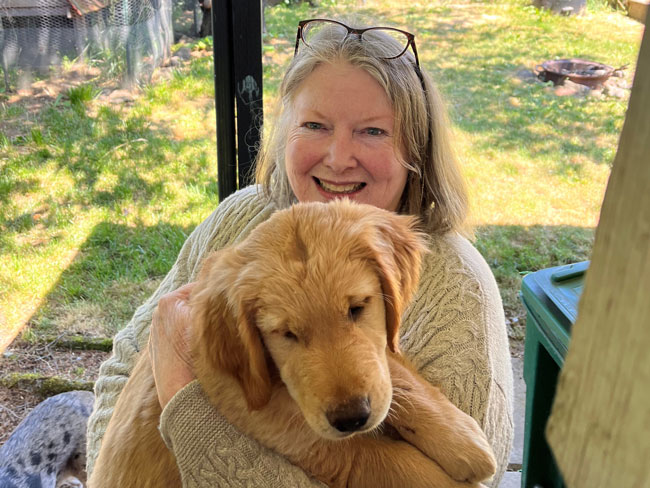 Maura holding a dog