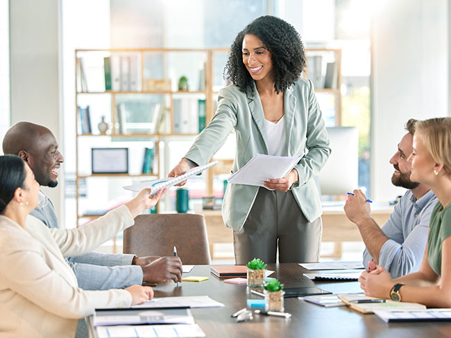 diverse group of employees meet around a table