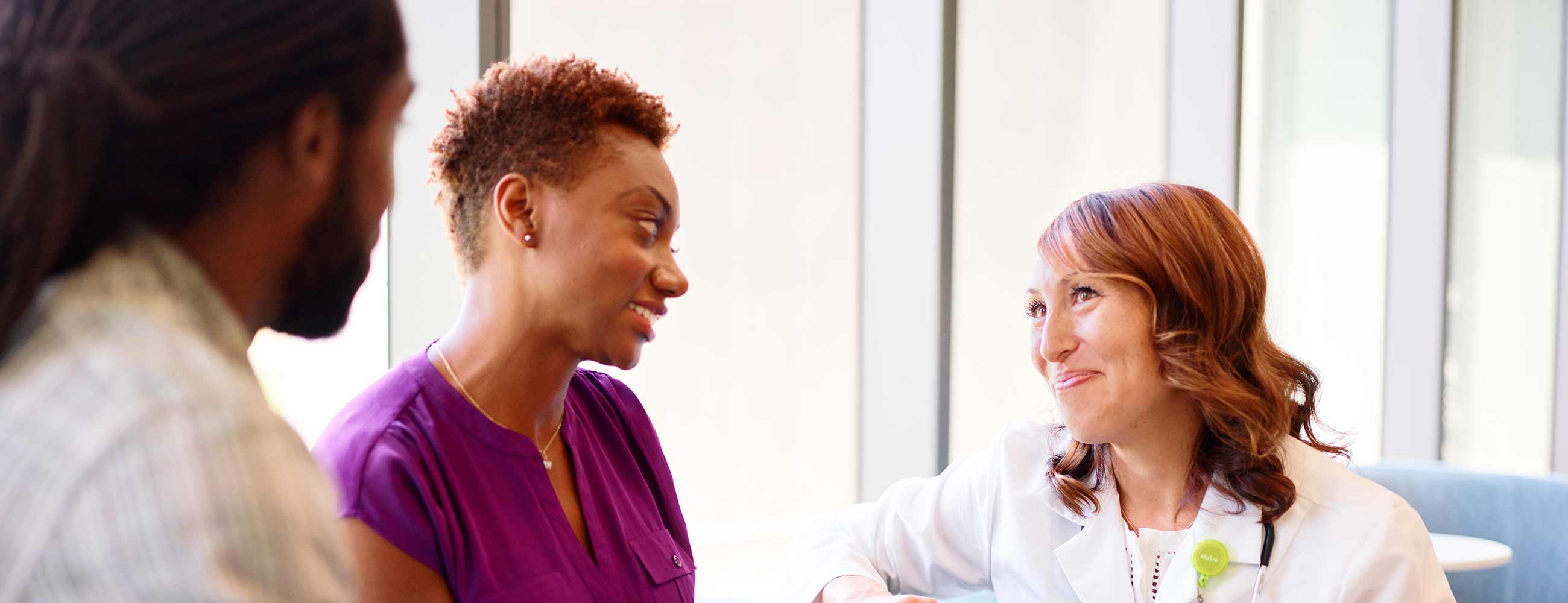 A physician consulting with a young couple.