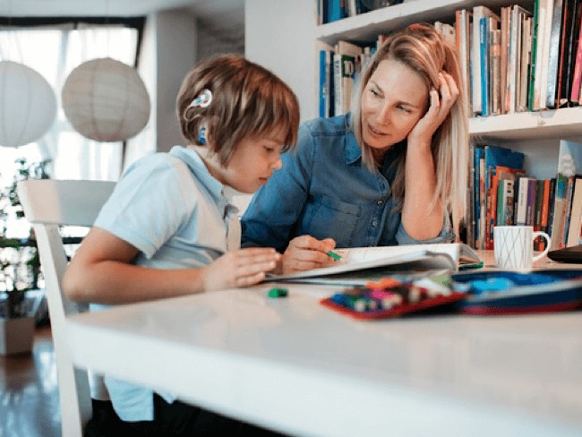 Woman tutoring young female student 