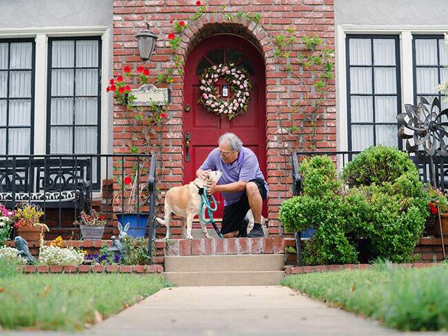 Michael Flores playing with dog