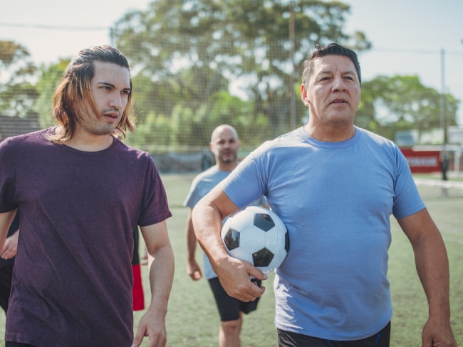 Two men standing on a soccer field