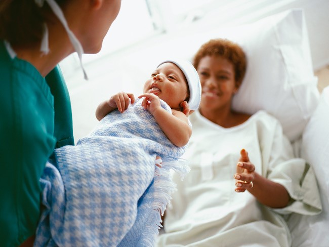 mother and newborn baby in hospital room