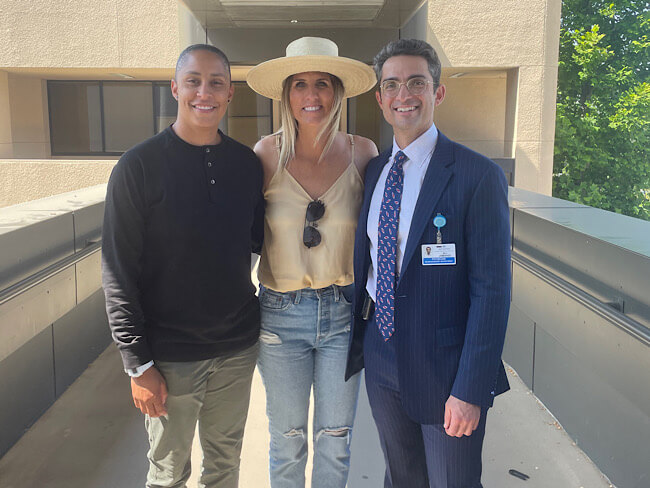 Wife, patient, and physician smiling  