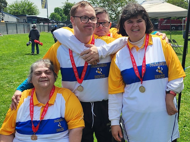 4 Pasadena Ducks athletes pose with their medals