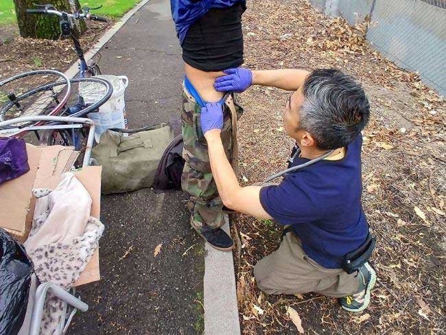 Dr. Leung examines a person's abdominal area