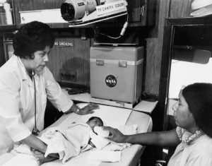 Interior view of the mobile health unit with medical personnel, neonatal patient and mother