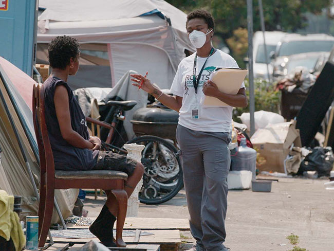 Volunteer talking to homeless woman