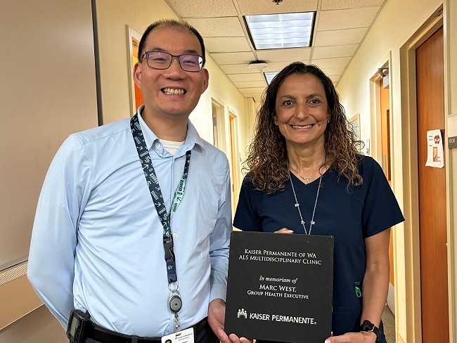 Dr. Eddie Tay and nurse Luci Wilcox holding award