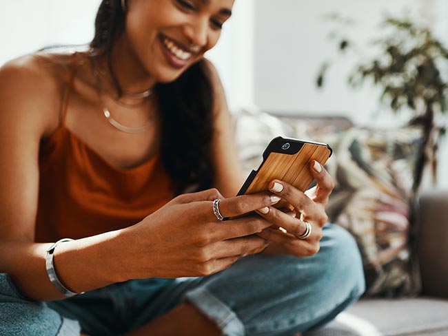 Smiling young woman looking at her smartphone.